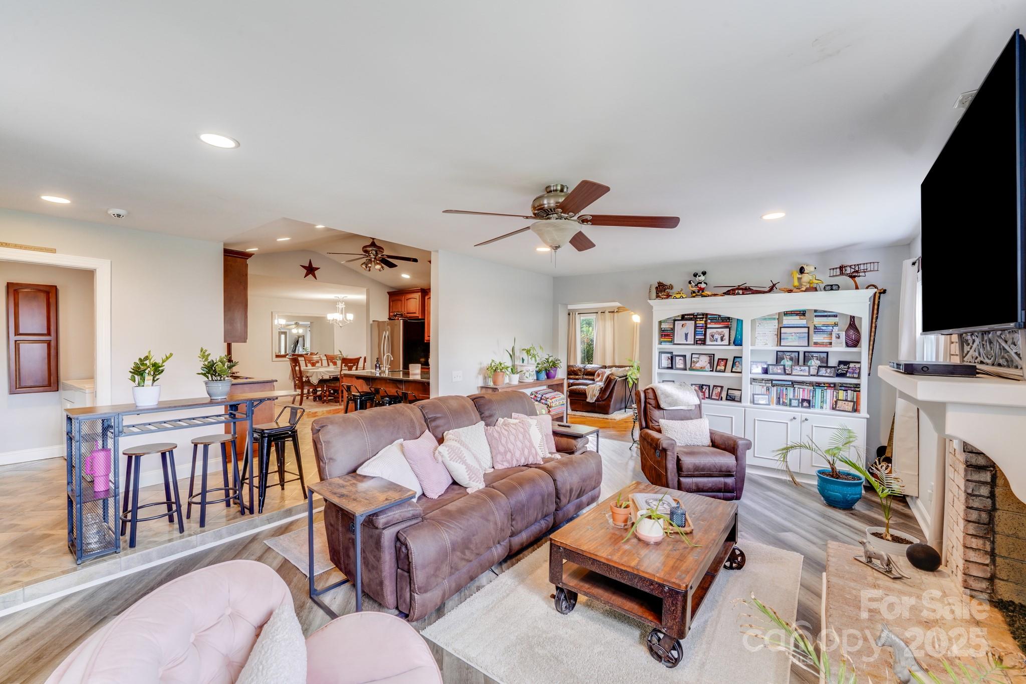 211 Drive Inn Road Locust, NC 28097 - Photo 37 of 48 a living room with fireplace furniture and a flat screen tv