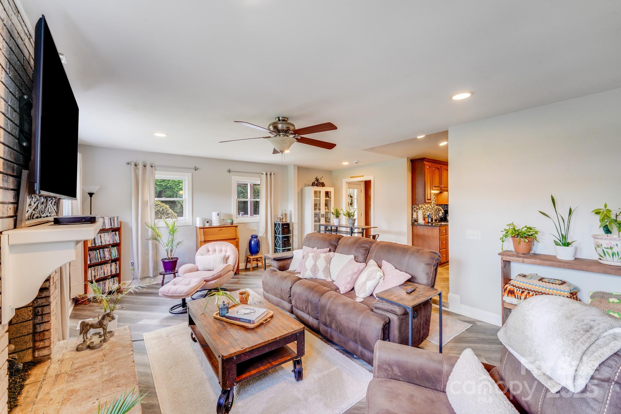211 Drive Inn Road Locust, NC 28097 - Photo 39 of 48 a living room with furniture and a flat screen tv