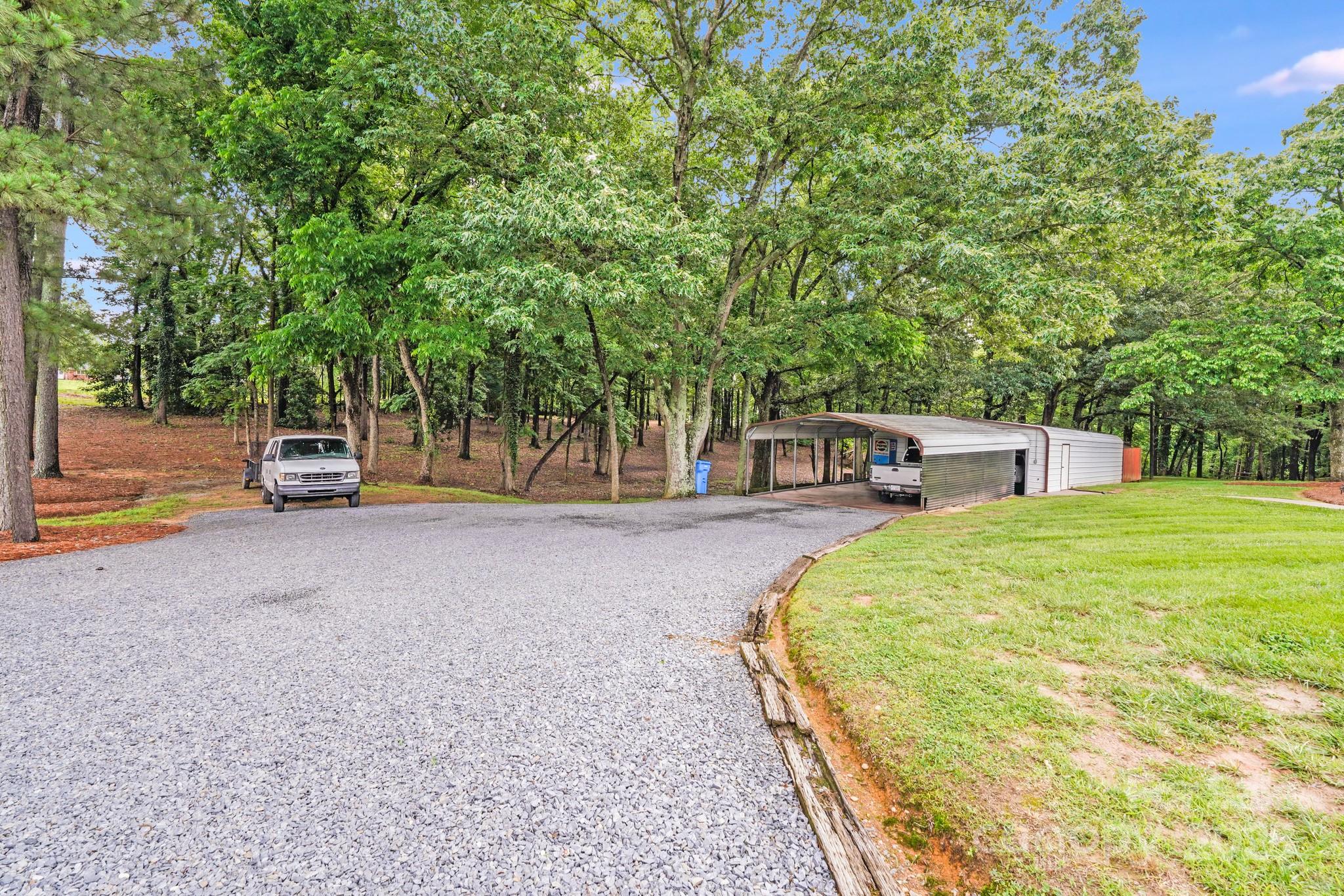 211 Drive Inn Road Locust, NC 28097 - Photo 8 of 48 a childrens park with large trees