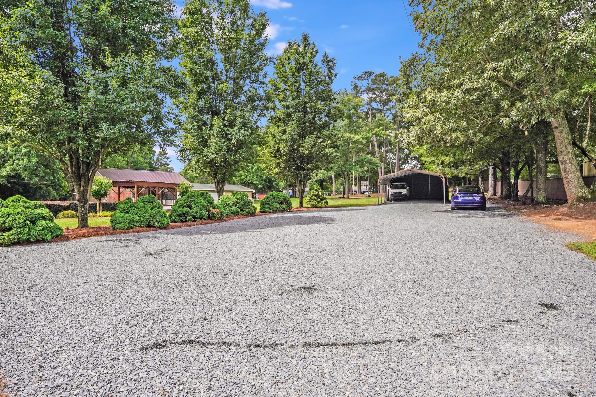 211 Drive Inn Road Locust, NC 28097 - Photo 9 of 48 a view of a road with trees in front of it