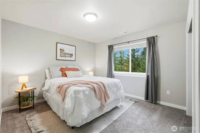 a bedroom with a bed and a painting on the wall