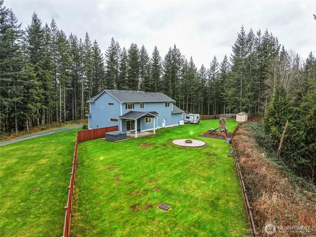a aerial view of a house with backyard and garden