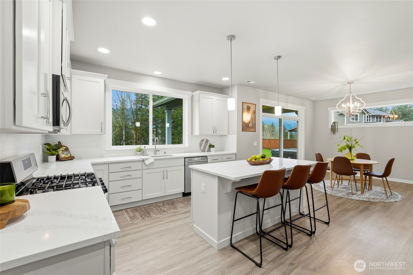 37311 142nd Place Southeast Sultan, WA 98294 - Photo 5 of 35 a kitchen with a dining table chairs and white cabinets
