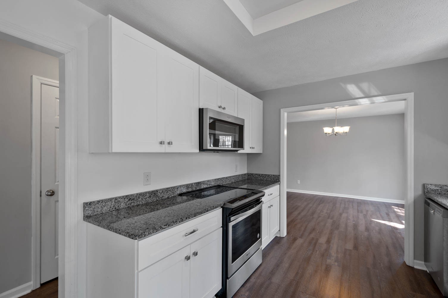 1004 Edwin Road Dickson, TN 37055 - Photo 14 of 36 a kitchen with granite countertop a stove and a microwave
