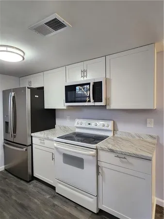 a kitchen with a stove microwave and refrigerator
