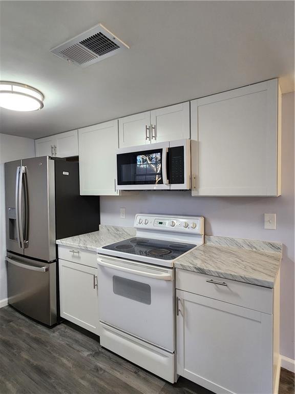 3543 Old Chamblee Tucker Road, Unit D Atlanta, GA 30340 - Photo 11 of 22 a kitchen with a stove microwave and refrigerator