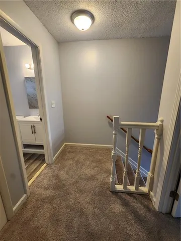 an empty room with a fireplace and painted walls