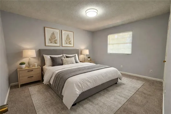 a bedroom with a bed and a night stand