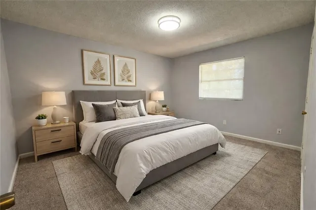 a bedroom with a bed and a night stand