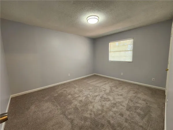 an empty room with a empty space and windows