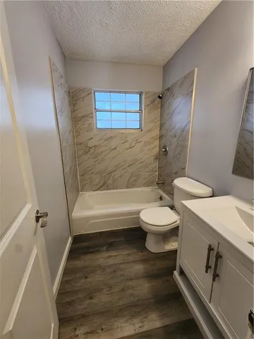 a bathroom with a toilet a sink and a bathtub