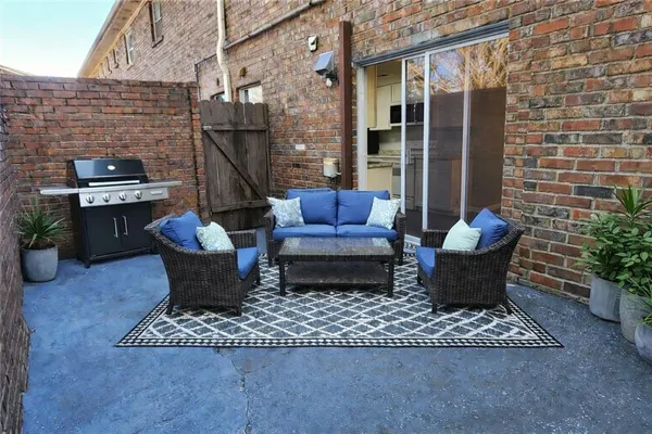 a view of a patio with couple of chairs and couch
