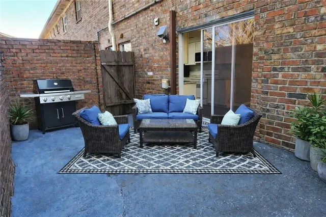 a view of a patio with couple of chairs and couch