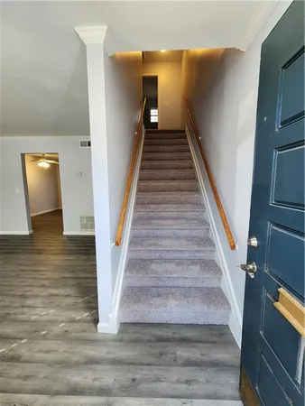 a view of entryway and hall with wooden floor