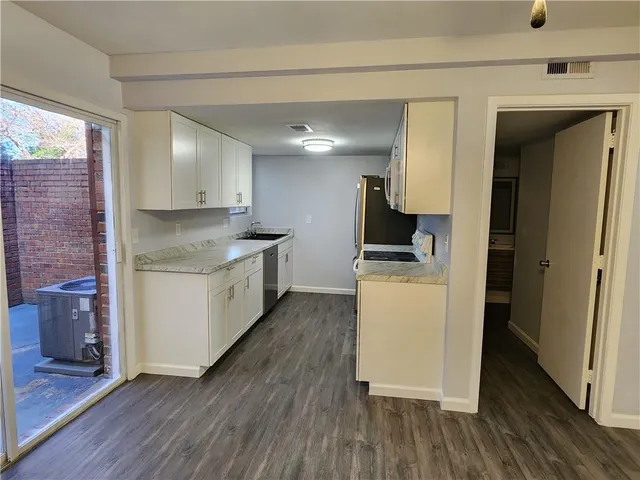 a kitchen with a sink and wooden cabinets