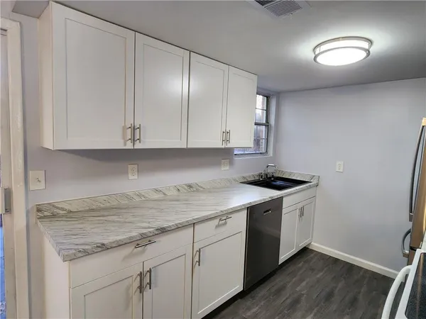 a kitchen with a sink and cabinets