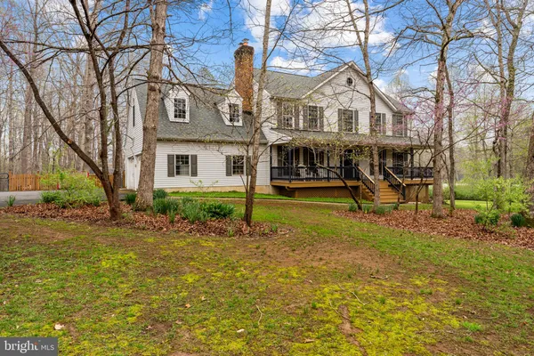 a view of house with outdoor space and garden