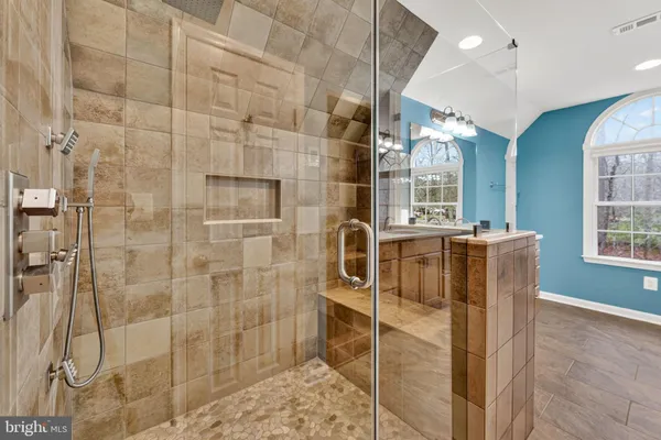 a utility room with a sink large mirror and a window