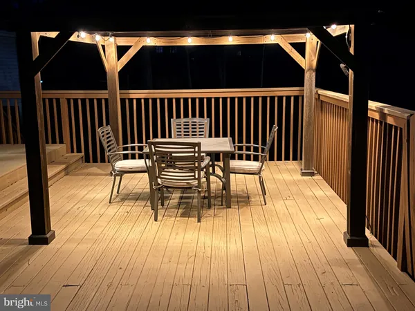 a view of a house with a wooden deck
