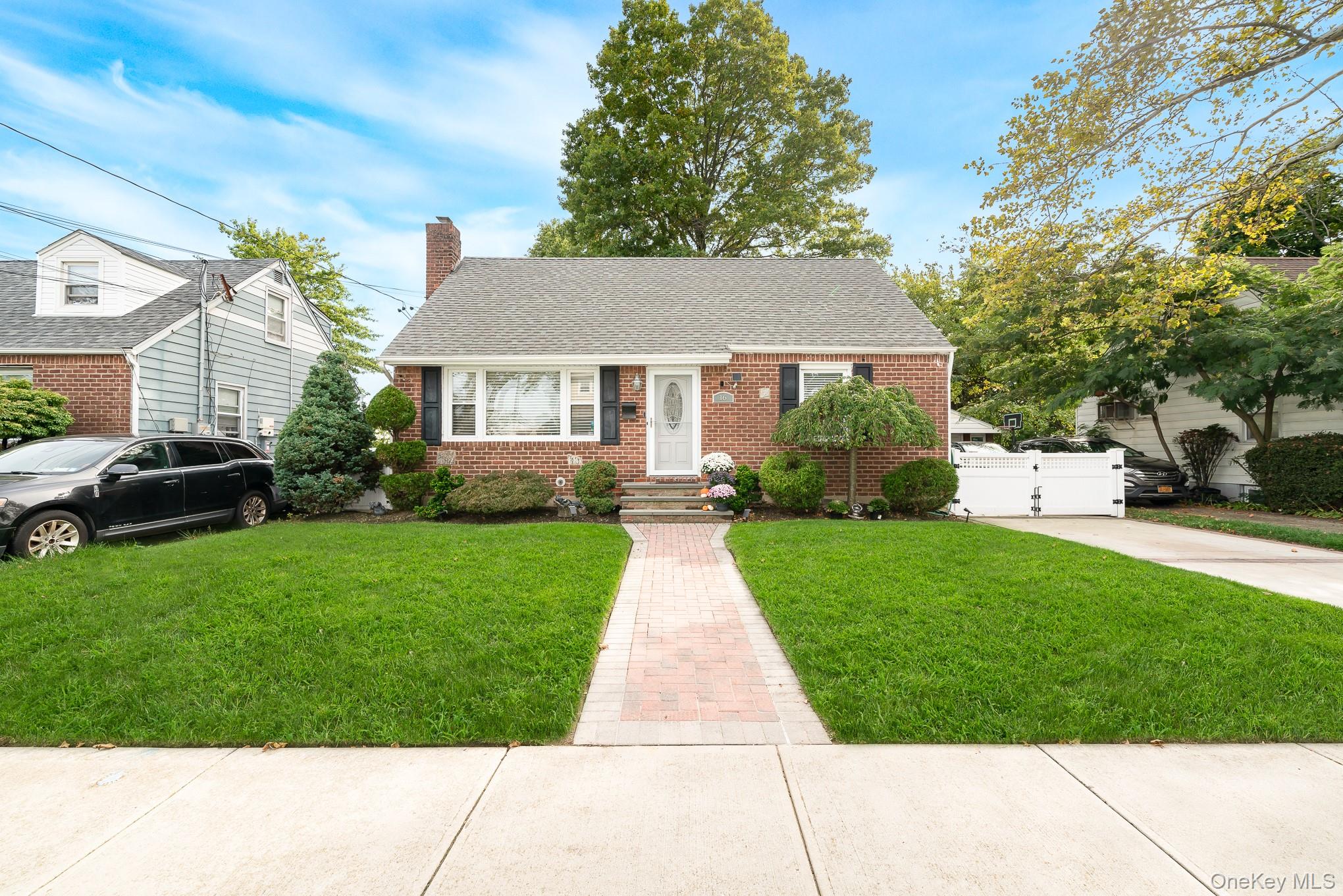16 Downs Road Hempstead, NY 11550 - Photo 1 of 1 Bungalow with brick siding, roof with shingles, and a chimney