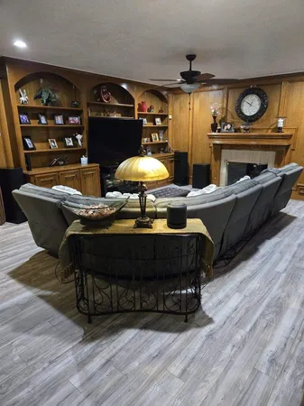 a living room with furniture and wooden floor
