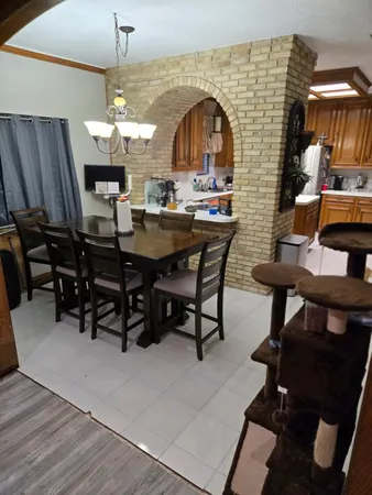 a view of a dining room with furniture and chandelier