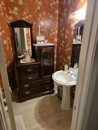 a bathroom with a sink a mirror and toilet