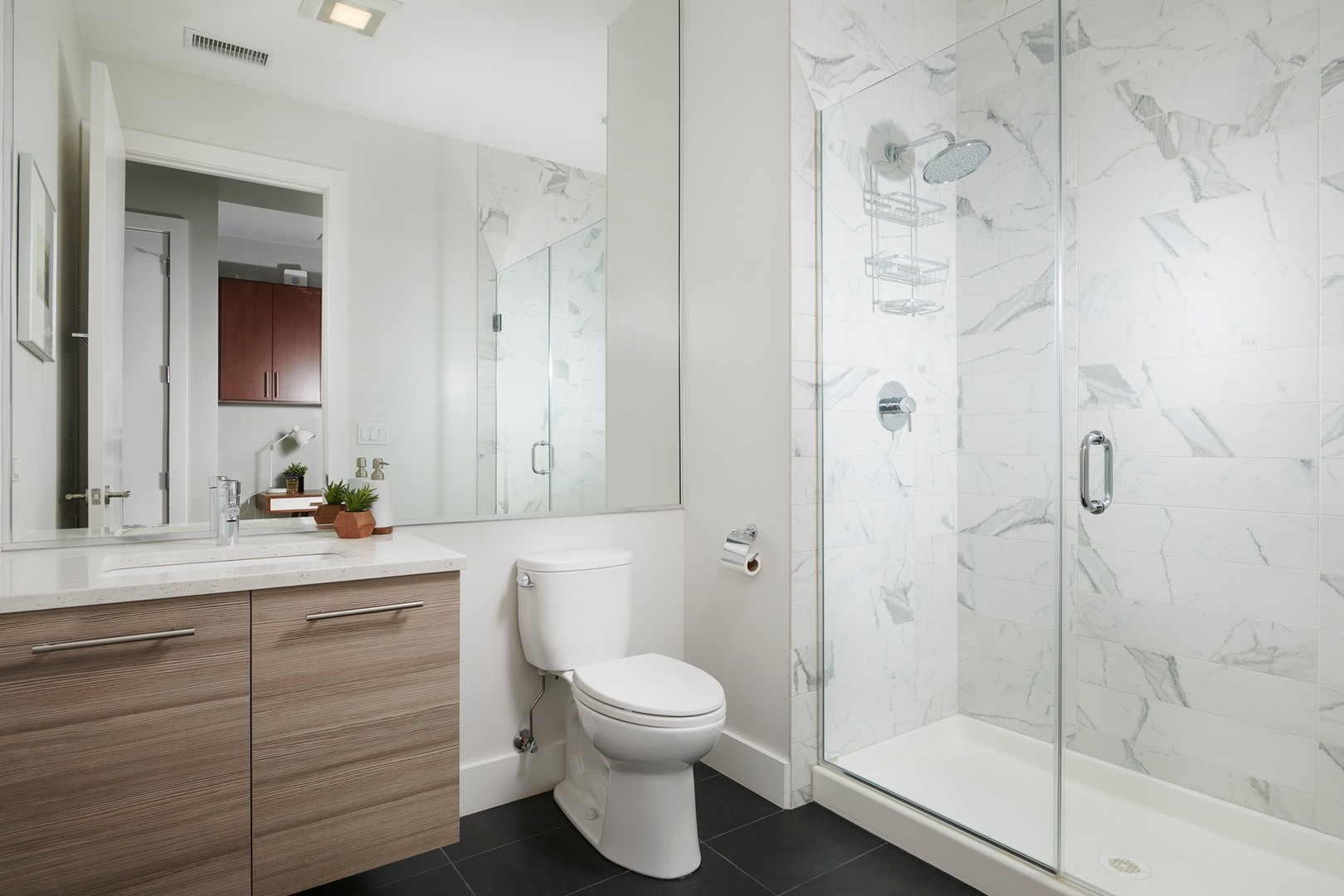 1100 West Adams Street, Unit 2N Chicago, IL 60607 - Photo 18 of 23 a bathroom with a toilet a sink and glass door