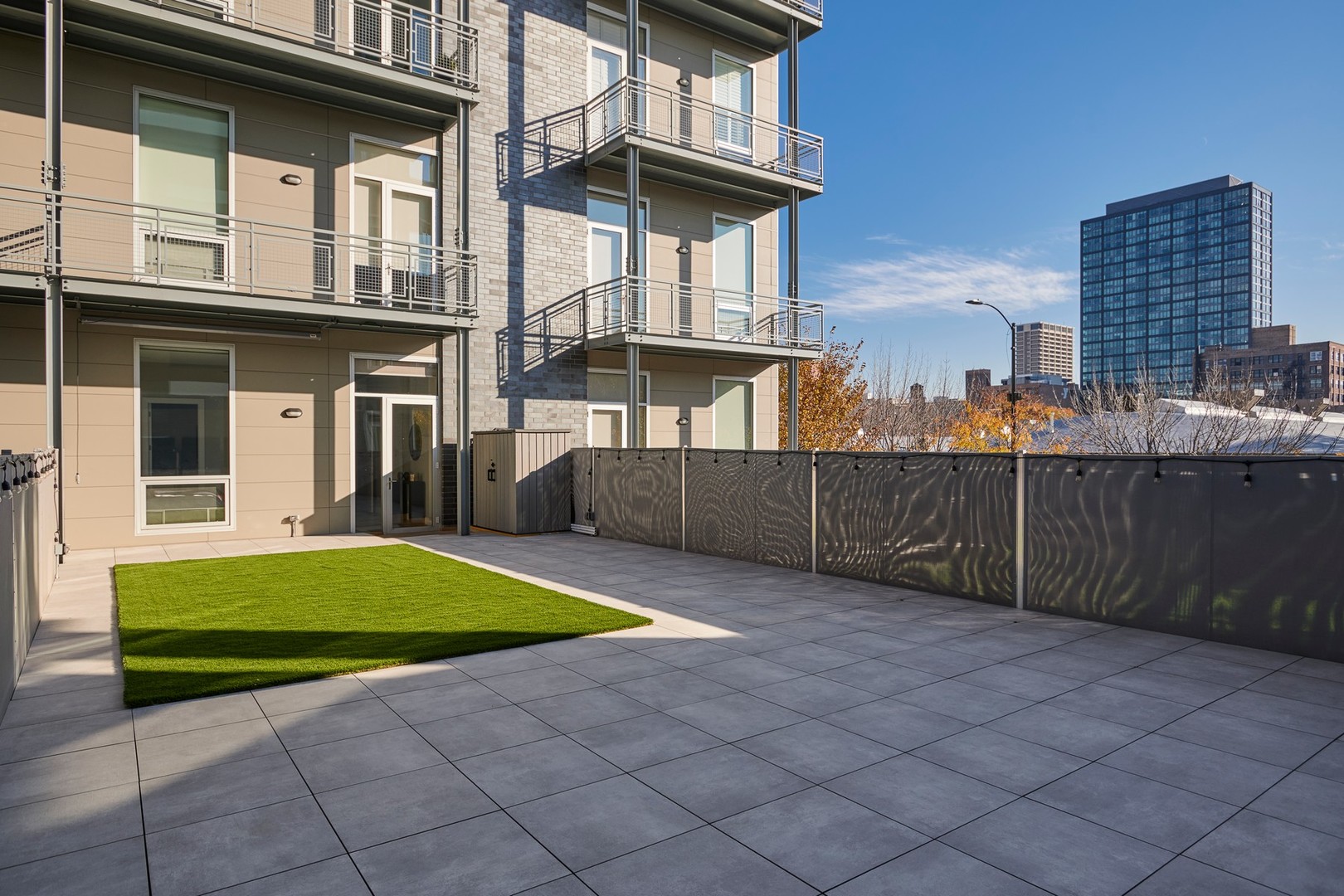 1100 West Adams Street, Unit 2N Chicago, IL 60607 - Photo 22 of 23 a view of a backyard with brick wall and a chair