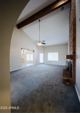a view of a hallway with a ceiling fan