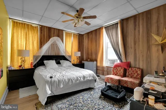 a bedroom with furniture and a large window