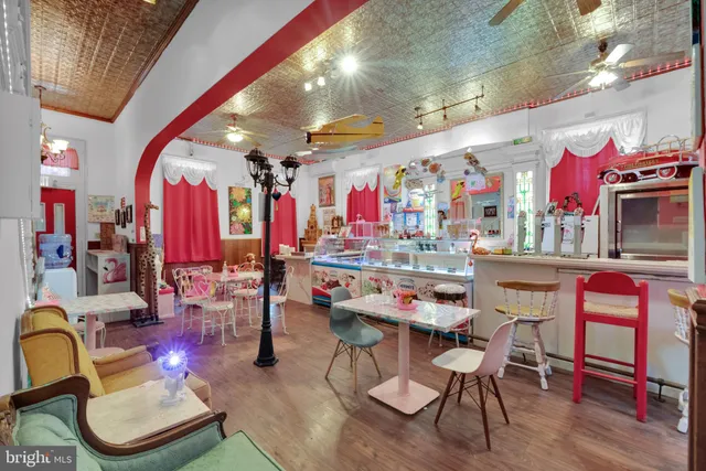 a living room with furniture ceiling fan and a window