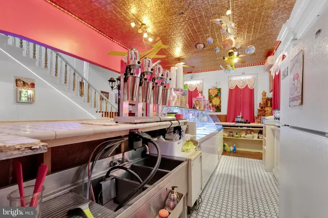 a kitchen with stainless steel appliances cabinets and wooden floor