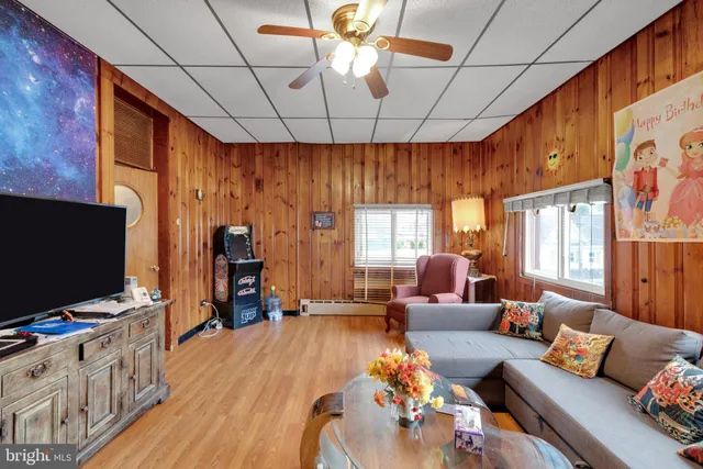 an aerial view of residential houses with outdoor space and trees