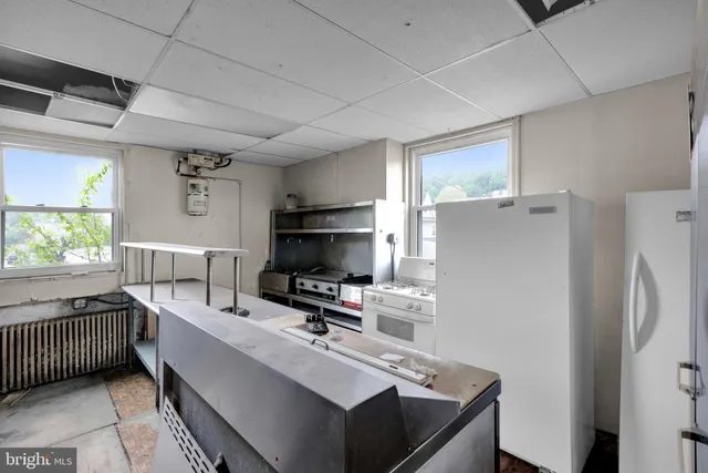 an aerial view of a house with a yard and a car park