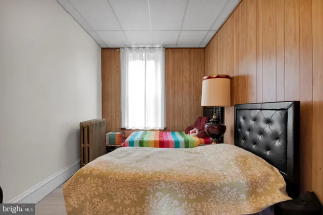 a bed room with a bed and a chair