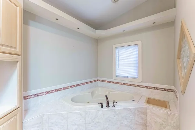 a bathroom with a tub and a shower