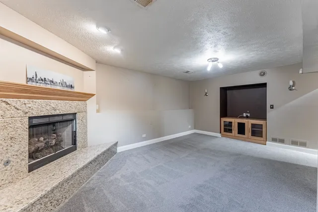 a view of an empty room with a fireplace