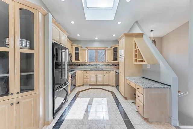 a view of a kitchen with a sink and wooden floor