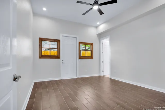 wooden floor in an empty room with a window