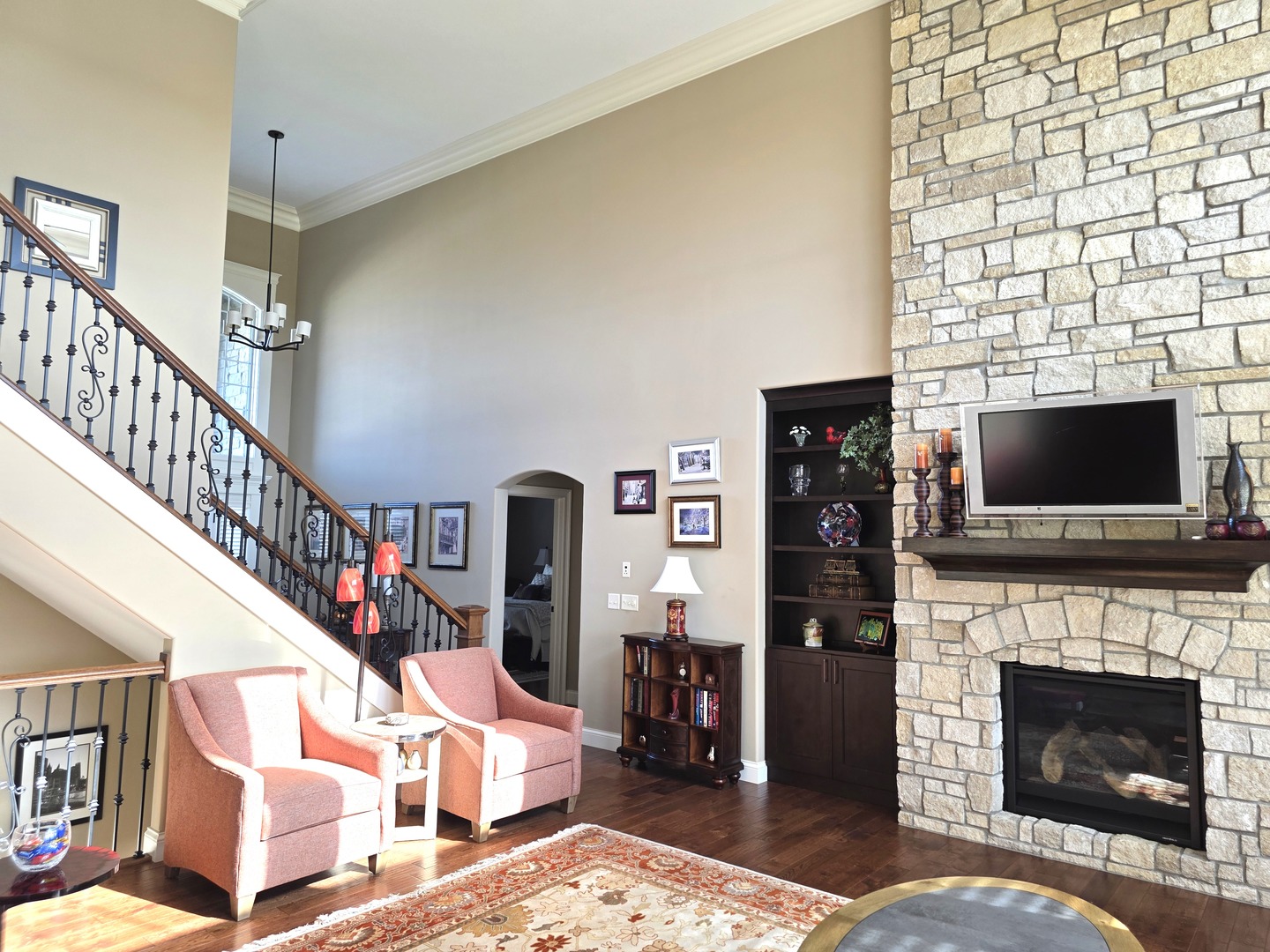 9667 Crossbow Drive Bloomington, IL 61705 - Photo 16 of 54 a living room with fireplace furniture and a flat screen tv