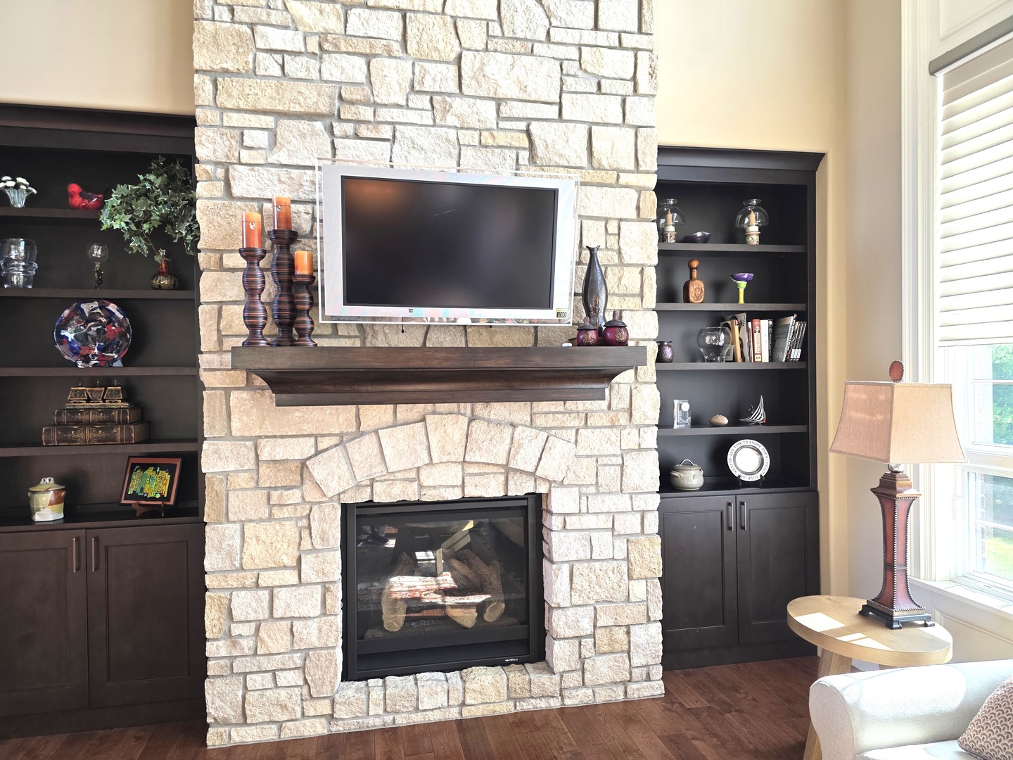 9667 Crossbow Drive Bloomington, IL 61705 - Photo 18 of 54 a living room with fireplace and a flat screen tv