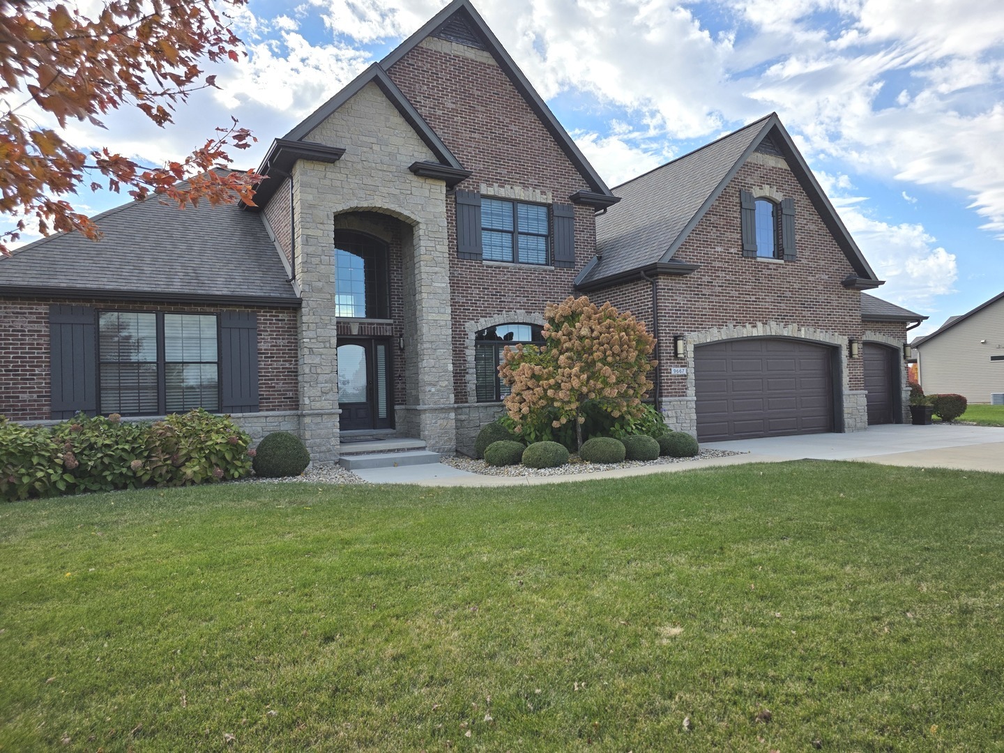 9667 Crossbow Drive Bloomington, IL 61705 - Photo 2 of 54 a front view of a house with a yard and garage