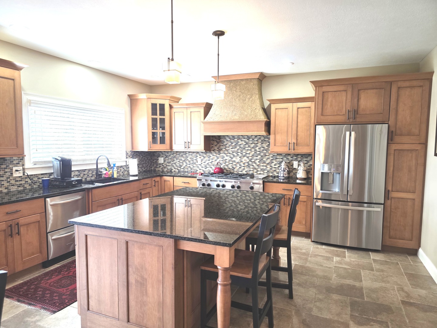 9667 Crossbow Drive Bloomington, IL 61705 - Photo 26 of 54 a kitchen with granite countertop a center island and stainless steel appliances