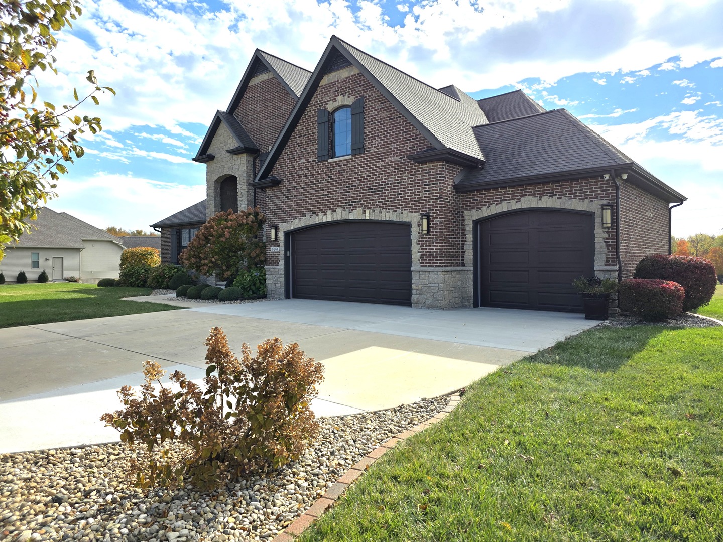 9667 Crossbow Drive Bloomington, IL 61705 - Photo 3 of 54 a front view of a house with a yard and garage