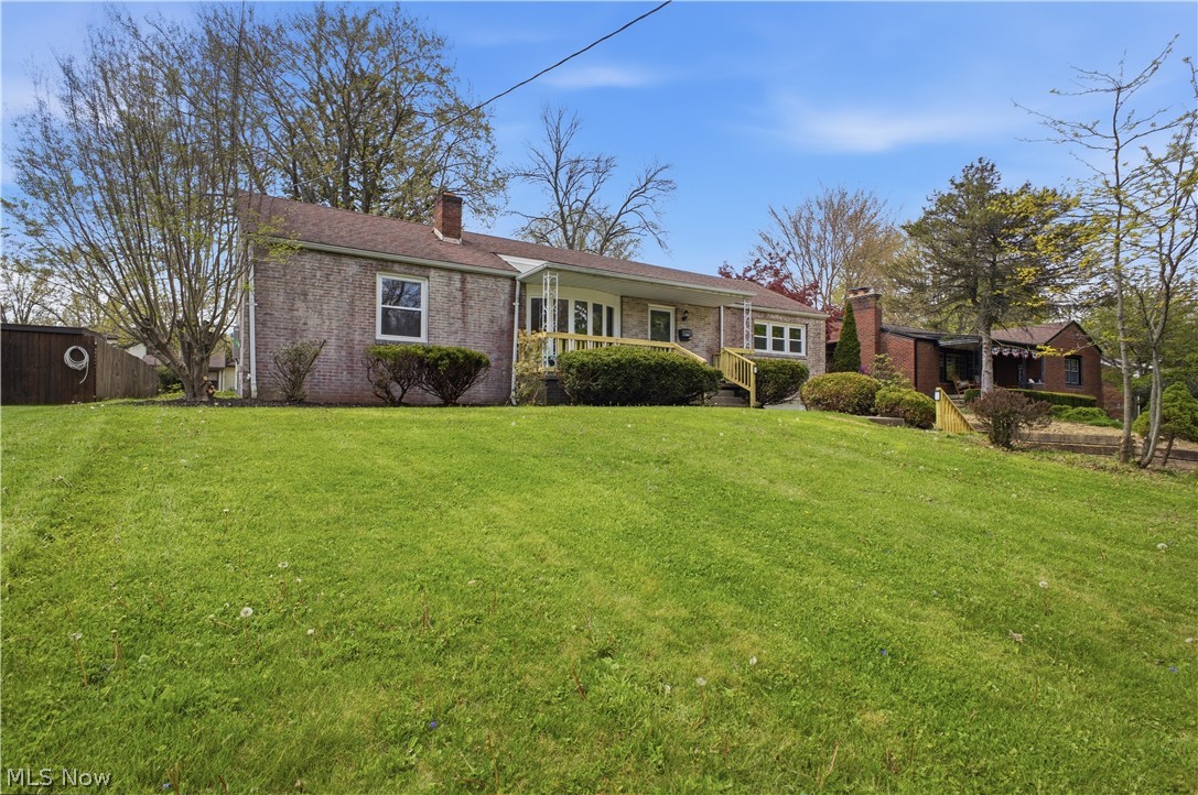 3232 Bears Den Road Youngstown, OH 44511 - Photo 35 of 38 Brick ranch-style residence featuring a sloped front lawn with established landscaping