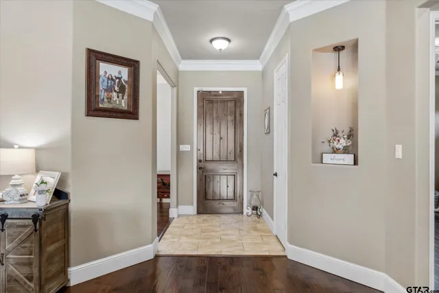 a living room with furniture a large window and wooden floor