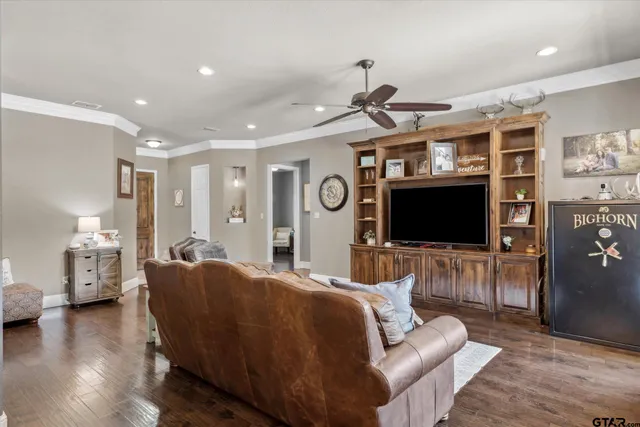 a living room with kitchen island furniture and a flat screen tv