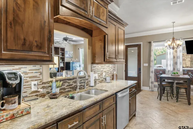 a bathroom with a granite countertop sink a mirror and shower