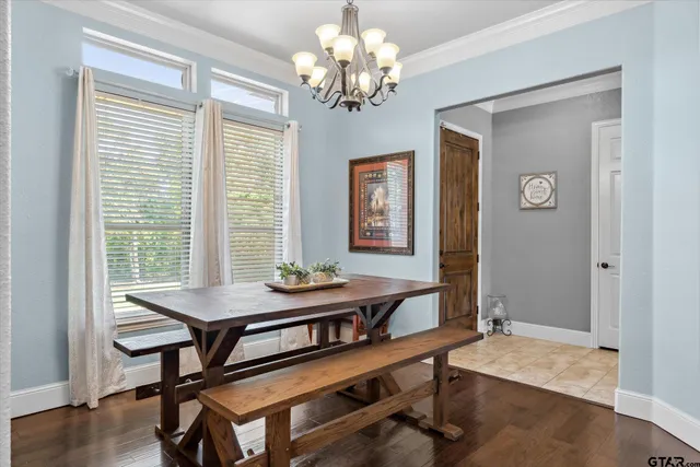 a bedroom with a large bed and a chandelier fan